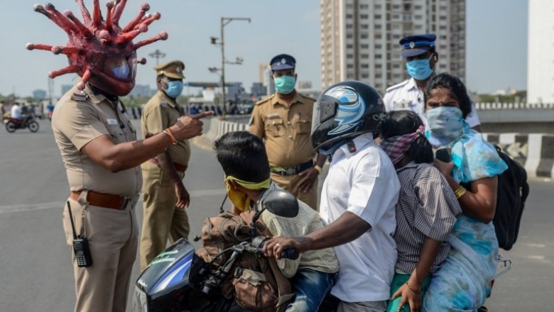 Policeman wears corona virus helmet to warn people to stay home